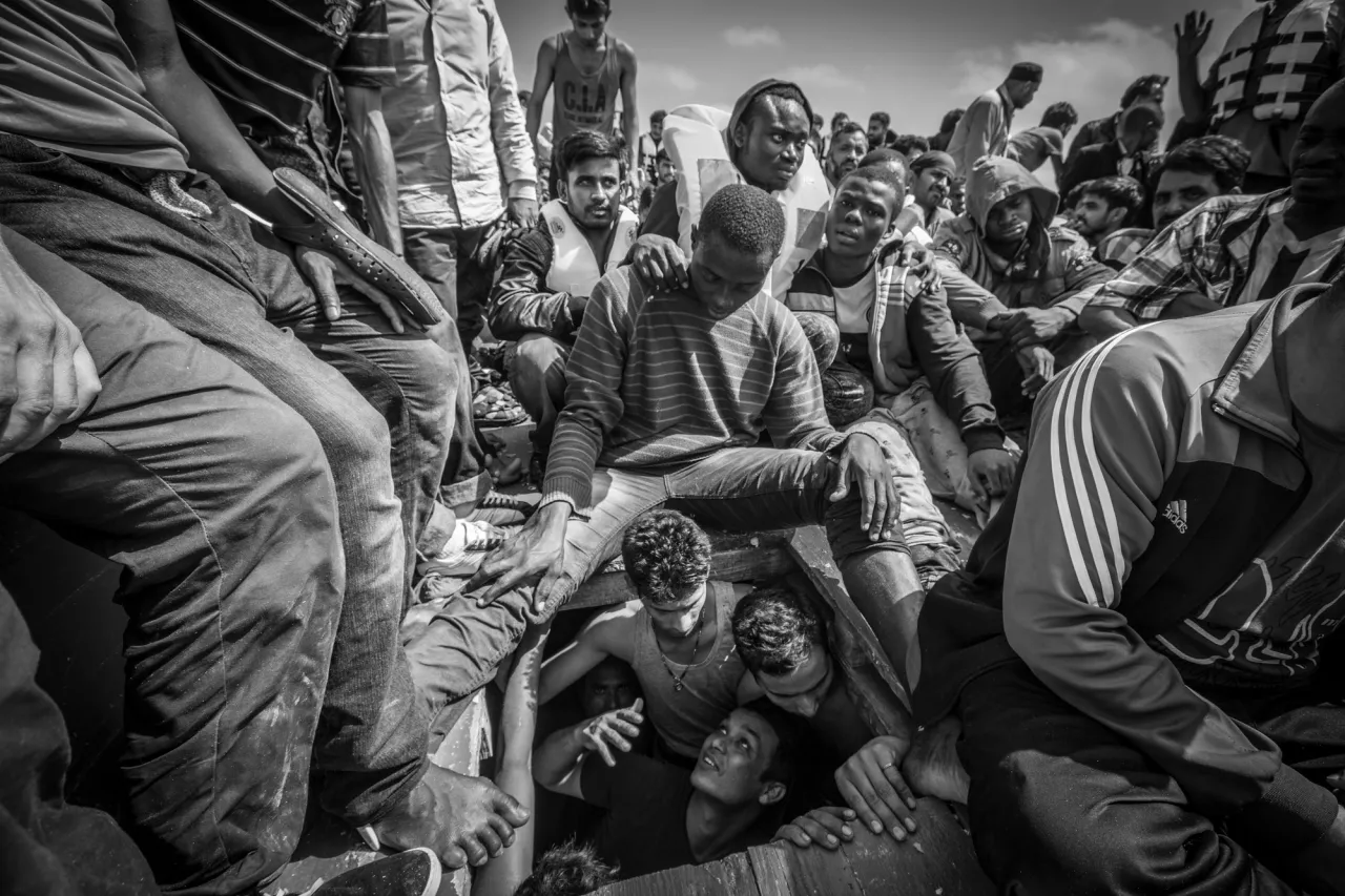 Onboard a fishing boat 30 miles off the coast of Libya, a Bangladeshi man begs to be released from the overcrowded hold of the boat where he was packed with 150 men in slaveship like conditions. The boat carried 414 migrants and refugees attempting to reach Italy. The migrant boat was intercepted by the NGO Migrant Offshore Aid Station’s rescue ship, and all the people onboard were evacuated. © Jason Florio. Photojournalism Series Winner, Magnum and LensCulture Photography Awards 2017