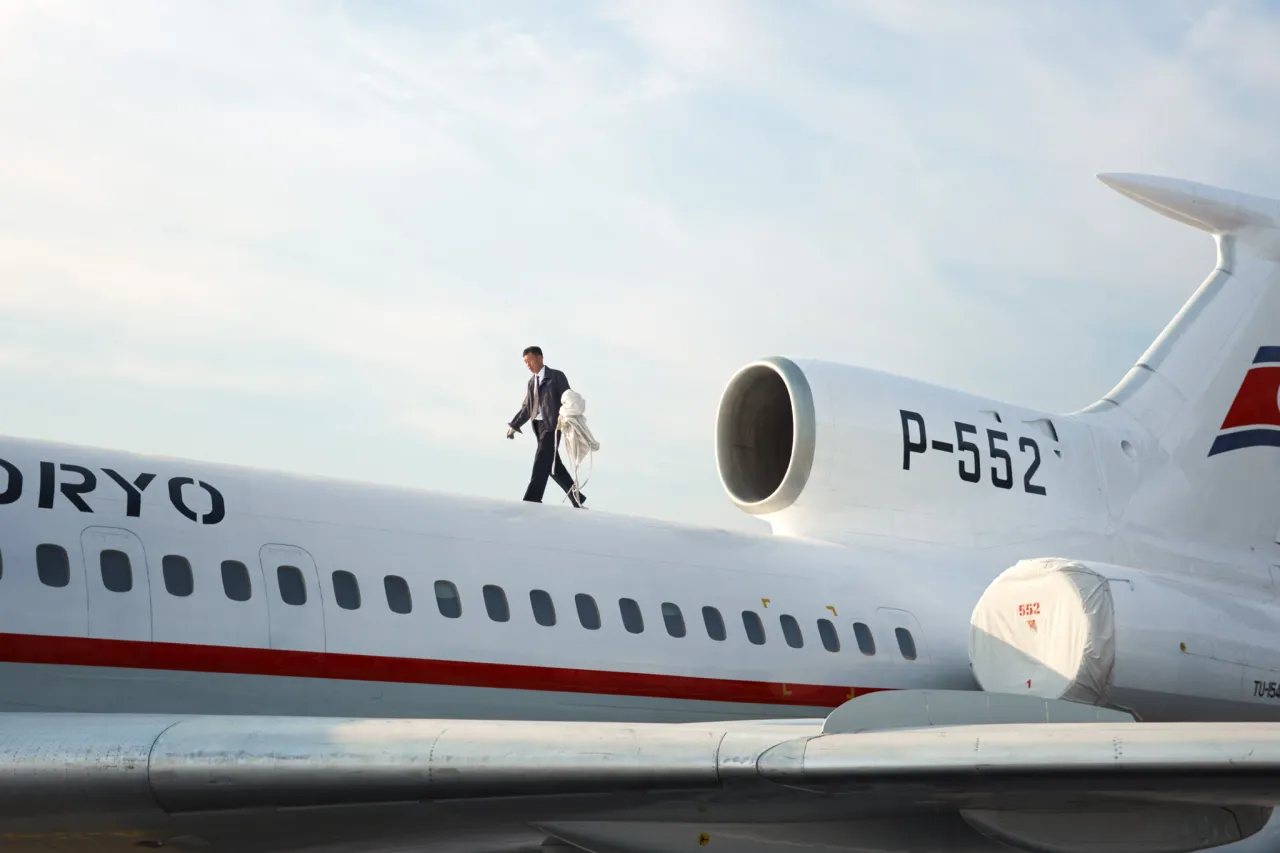 A Pilot removes the engine covers of a Tupolev-154 before flight