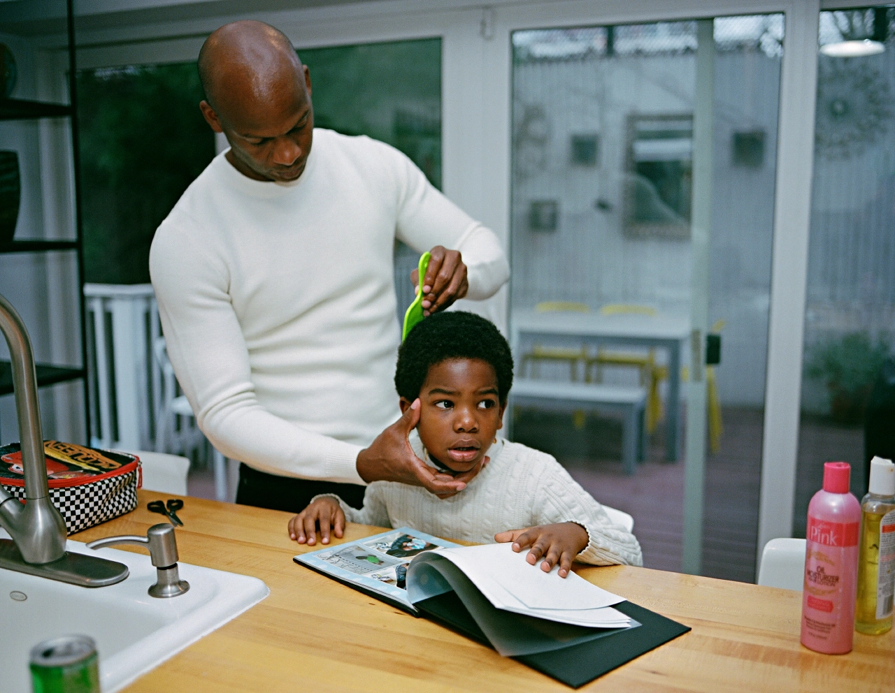 Dennis combing Élan’s hair. Brooklyn, New York © Bart Heynen from 'Dads' published by powerHouse Books
