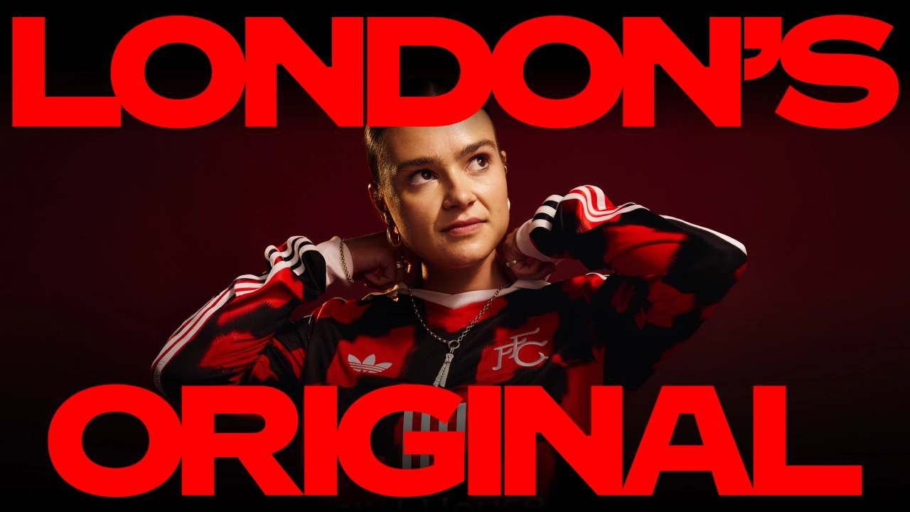 Person wearing red and black Fulham FC kit with hands near head, against red background with "London's Original" text overlay