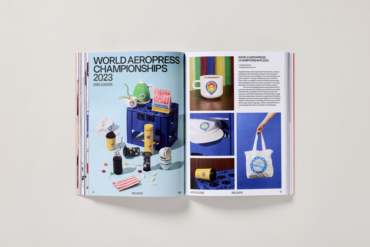 Open magazine spread showing World Aeropress Championships 2023 project with colourful merchandise including a blue box, green globe, yellow container and coordinating branded items displayed alongside product photography
