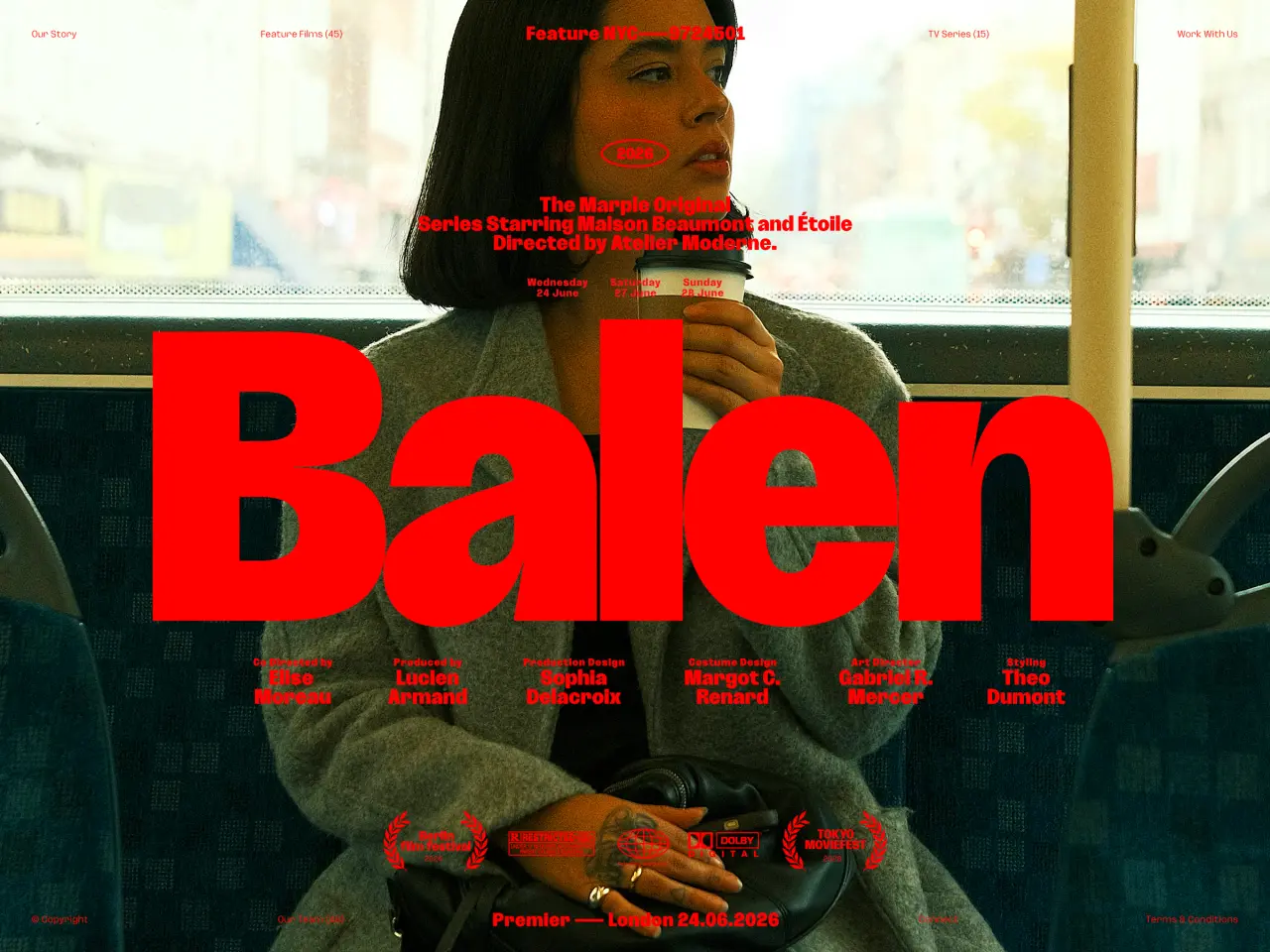 Woman with long dark hair in grey jacket holding a beverage, overlaid with large red "Balen" text on a bus interior setting