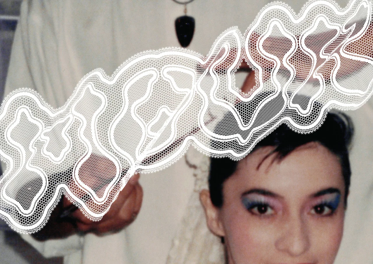 Person wearing white lace collar with intricate geometric cutout patterns inspired by traditional lace designs