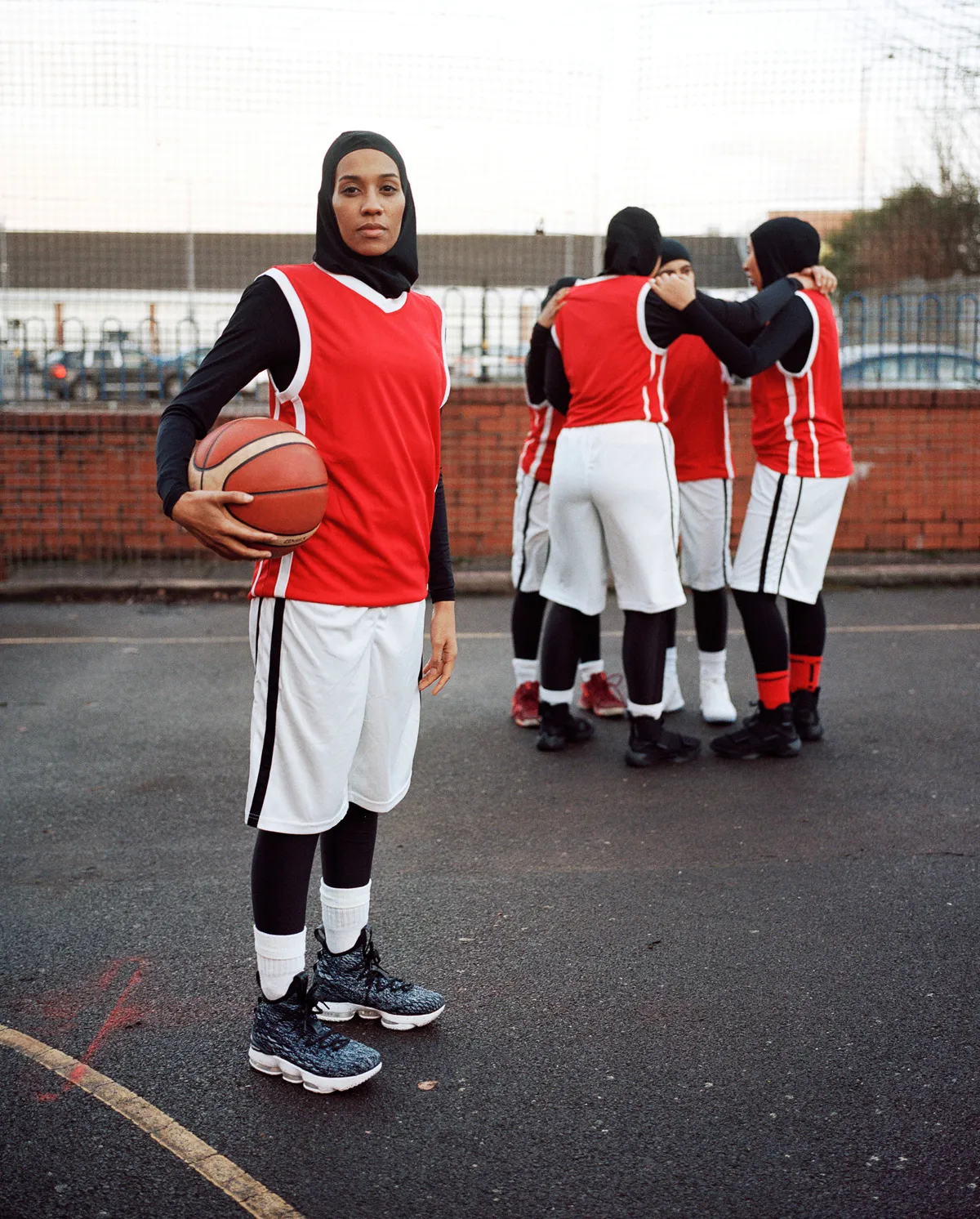 "Asma, a member of an all-female Muslim basketball team, is pictured with some of her teammates. They are part of a worldwide campaign that is urging the International Basketball Federation to lift the ban on religious headgear in elite sports." – Asma © Sophie Green