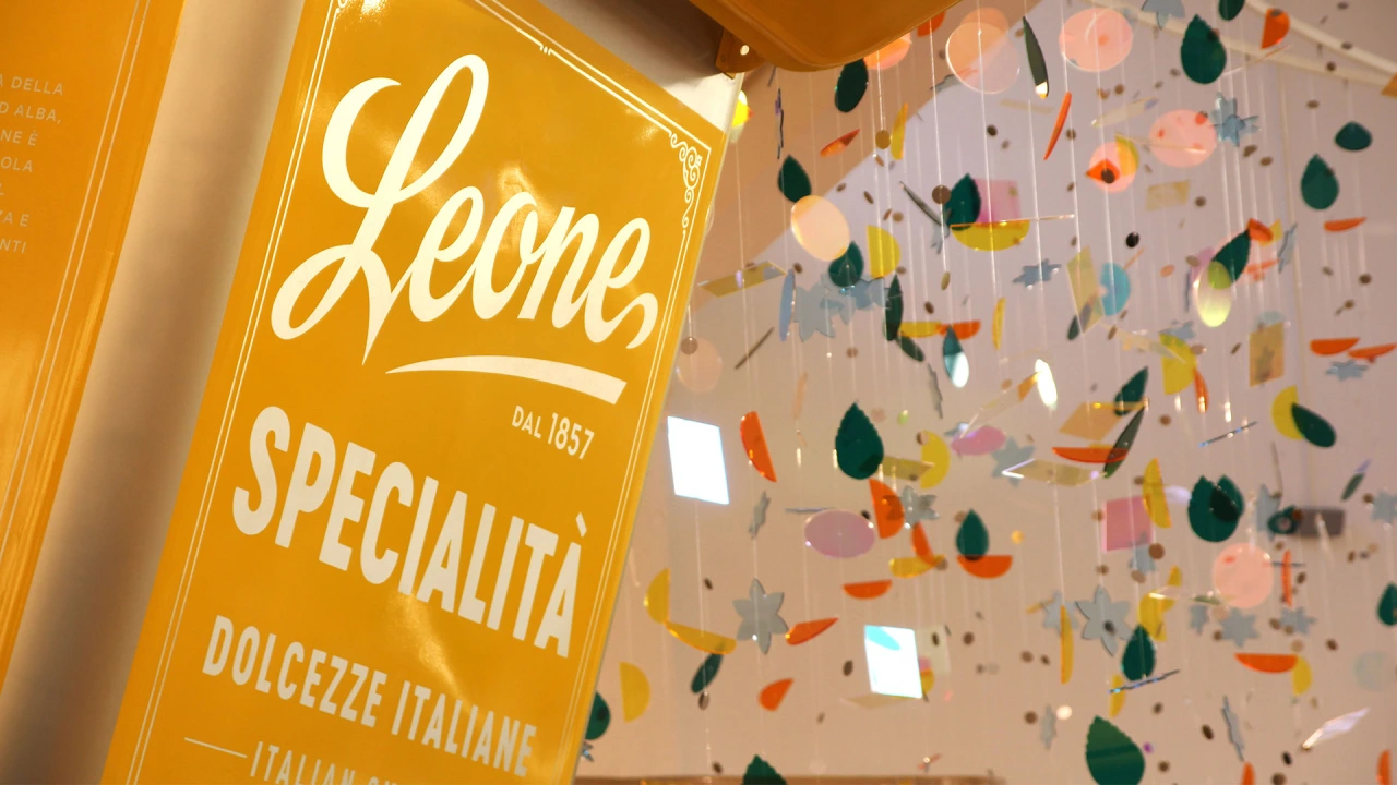 Leone Specialità yellow box displayed beneath hanging colourful confetti-like decorations in the Happiness Factory installation