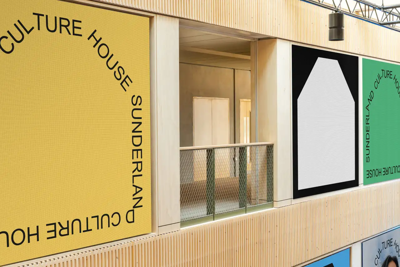 Culture House Sunderland's bright yellow and green facade with signage and window displays featuring geometric shapes