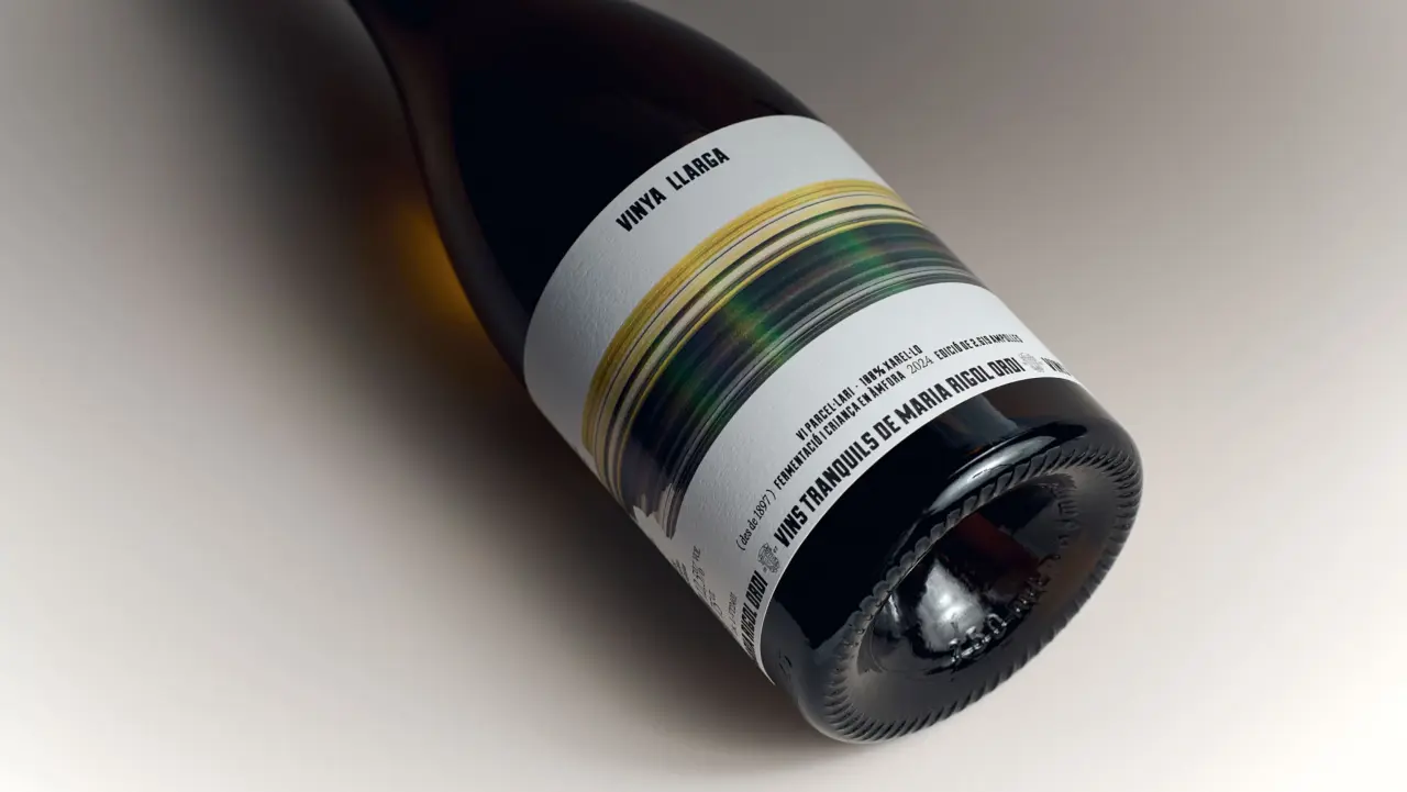 Vinya Llarga wine bottle with a label featuring horizontal bands of yellow, green and blue streaks that wrap around it, designed to resemble a blurred landscape viewed from a moving train