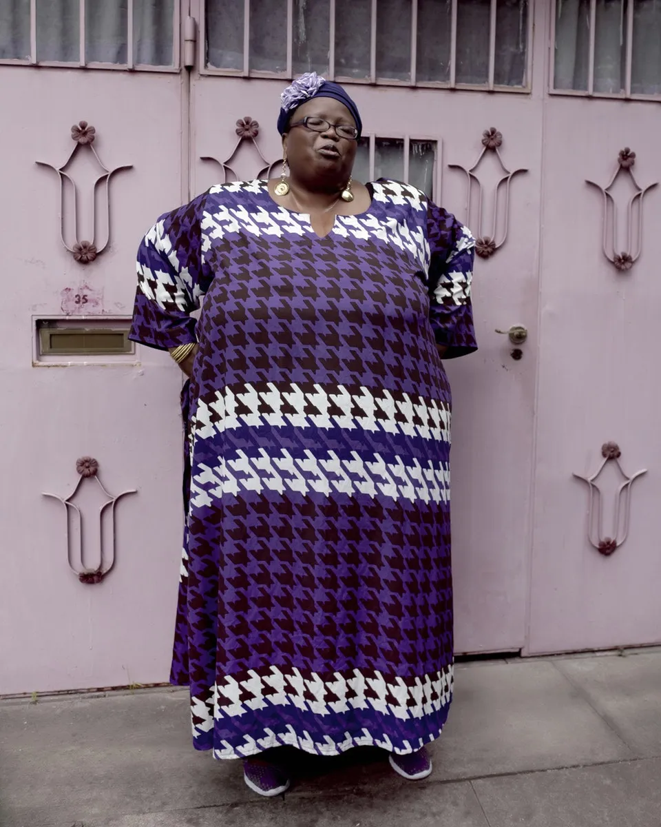 Valerie, London © Amanda Fordyce. "I noticed Valerie as she was walking down the street carrying groceries. I thought she looked beautiful and very stylish. We had a little chat and she kindly agreed to walk to a purple garage door I’d just passed."