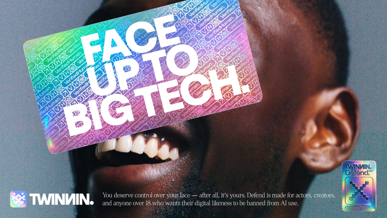 Person's face obscured by a holographic rainbow gradient sticker reading "Face up to big tech" with binary code pattern and Twinnin branding