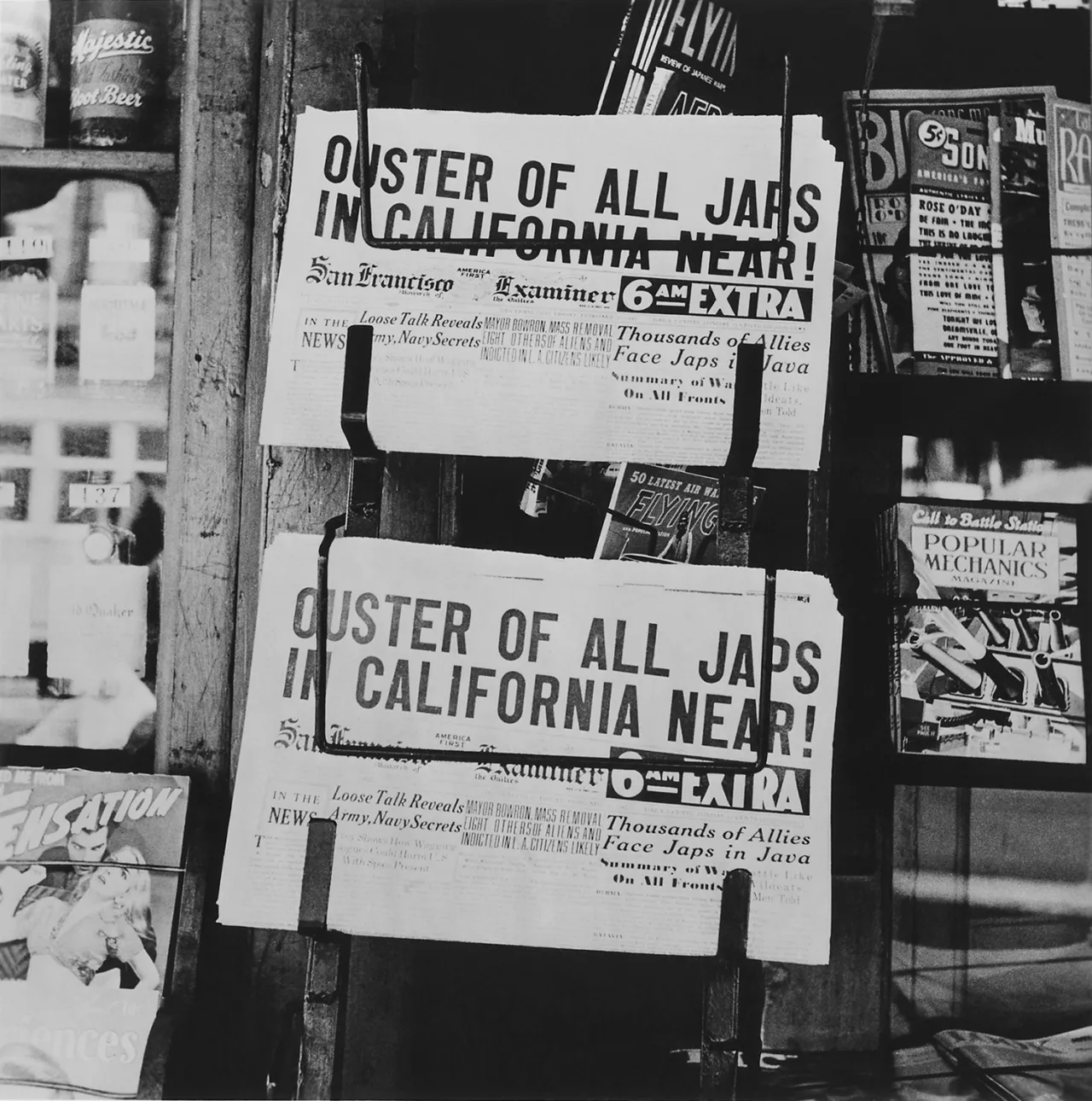 Newspaper front pages pinned to a pole with headlines reading "Oyster of All Jabs in California Near!", San Francisco Examiner extras, depicting anti-Japanese American sentiment during World War II