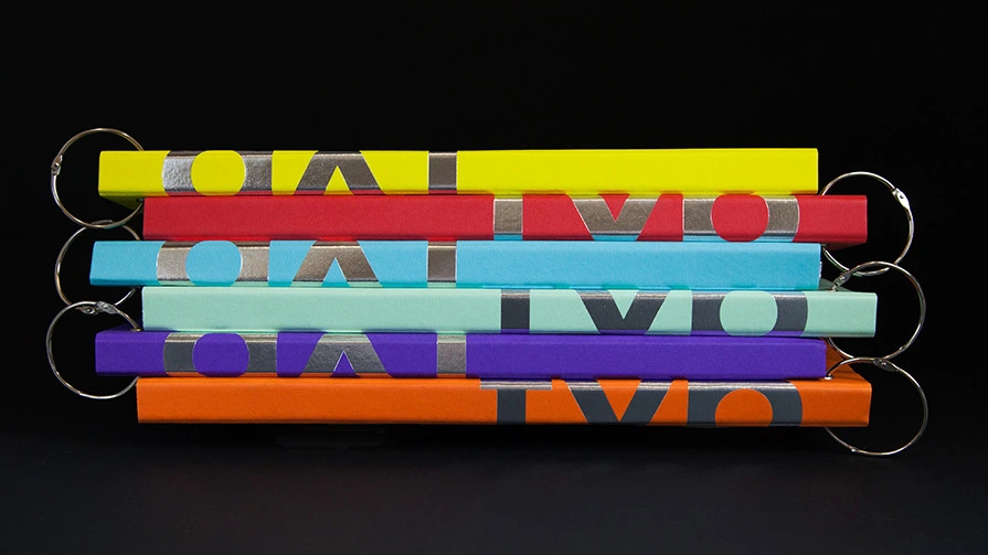 Five coloured belts stacked horizontally featuring grey text and circular elements in yellow, red, cyan, purple and orange