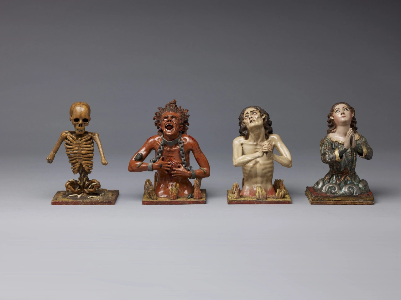 Attributed to Manuel Chili, called Caspicara, The Four Fates of Man: Death, Soul in Hell, Soul in Purgatory, Soul in Heaven, Ecuador c. 1775. On loan fromThe HIspanic Society of America, New York, NY. 'Spain and the Hispanic World: Treasures from the Hispanic Society Museum & Library' exhibition at the Royal Academy of Arts, London (17 January - 10 April 2023). Photo: © Royal Academy of Arts, London / David Parry
