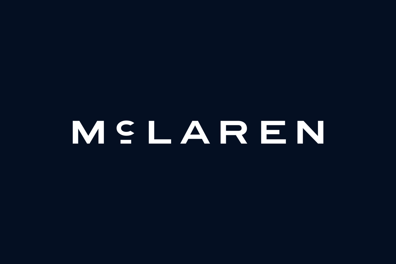 McLaren's new wordmark in white lettering on a dark background, inspired by the hand-painted sign from Bruce McLaren's family garage in Auckland