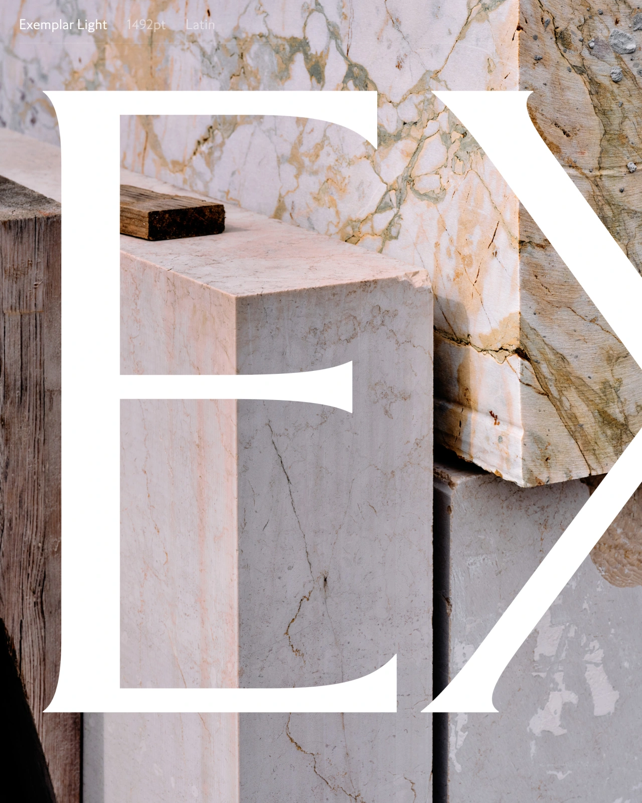 Marble plinth with geometric white letterforms overlaid, surrounded by weathered stone and wooden textures