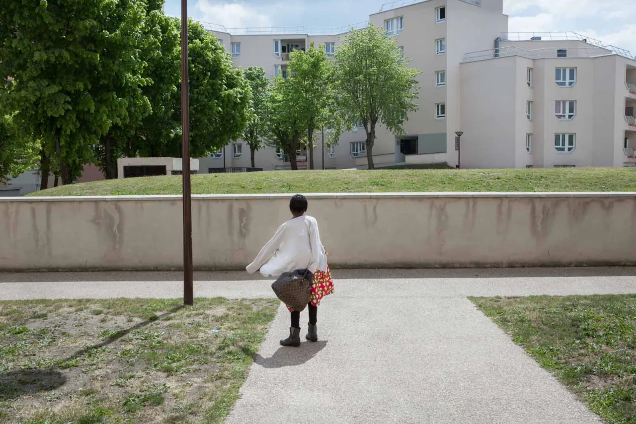 A girl observes the buildings around. Deuil-la-Barre, Ile de France, France From the series ‘First Generation’ © Carolina Arantes