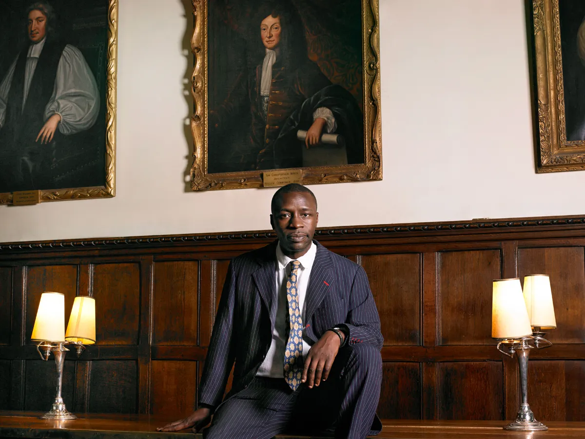 "Diran is a British writer who wrote a very moving novel about a young black man who studied at Oxford. I made this portrait of Diran, who was himself a student at Oxford, as part of an initiative to encourage people other than white males to apply to study at the university." – Diran Adebayo in front of a portrait of Sir Christopher Wren ( An Ordinary Commoner) Oxford © Rory Carnegie