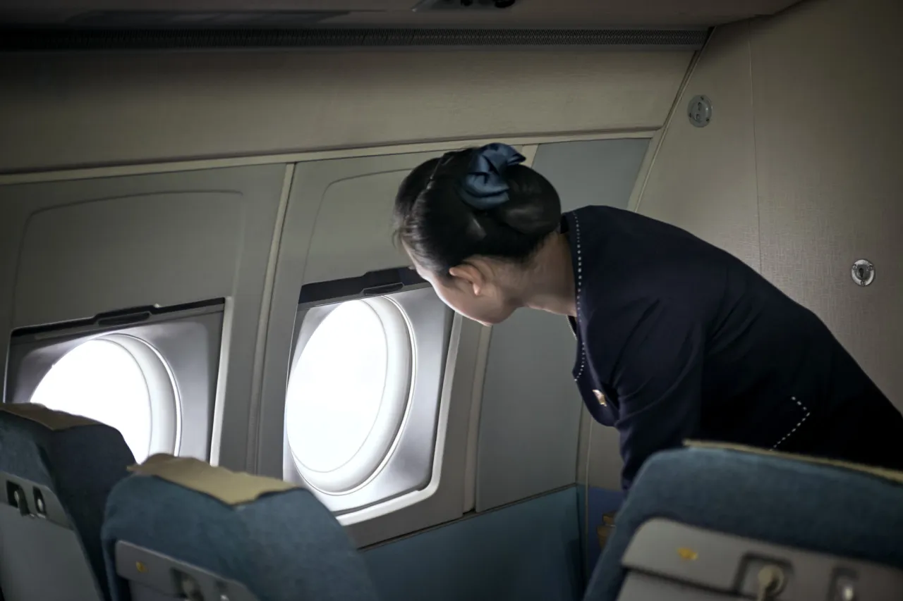 A stewardess of the Ilyushin-62 checking on ground personal just after landing