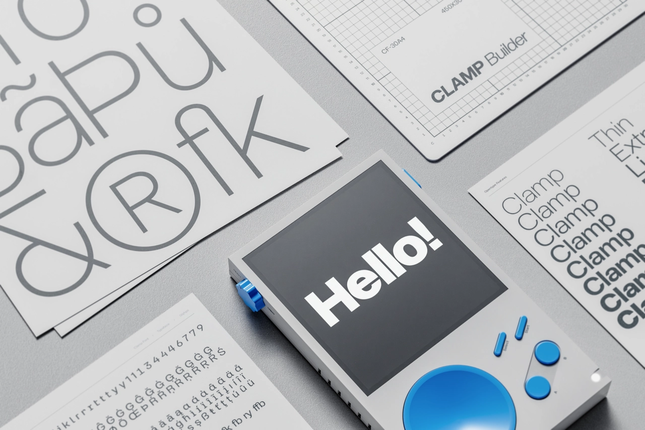 A 3D rendered device displaying "Hello!" on a dark screen, surrounded by design sketches and typography samples with blue accents