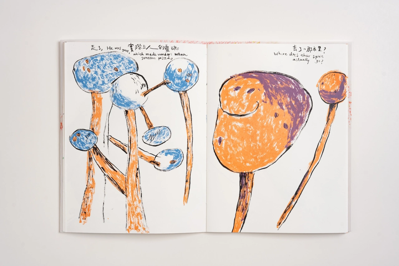 Open sketchbook pages with colourful drawings of smiling stick figures made from blue and orange spheres connected by brown lines, with handwritten notes in Japanese and English