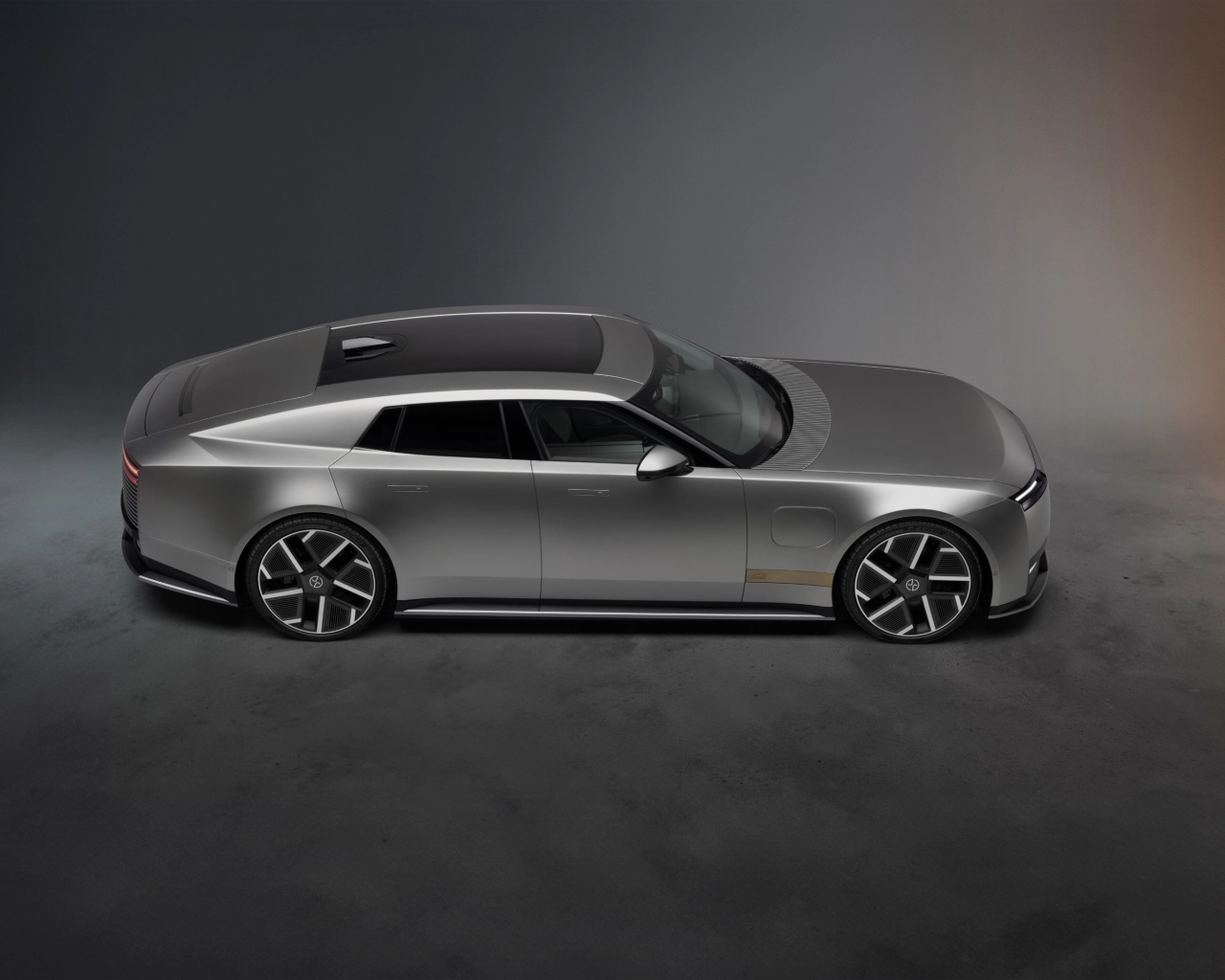 Silver Jaguar Type 01 luxury car shown in profile against a neutral grey background