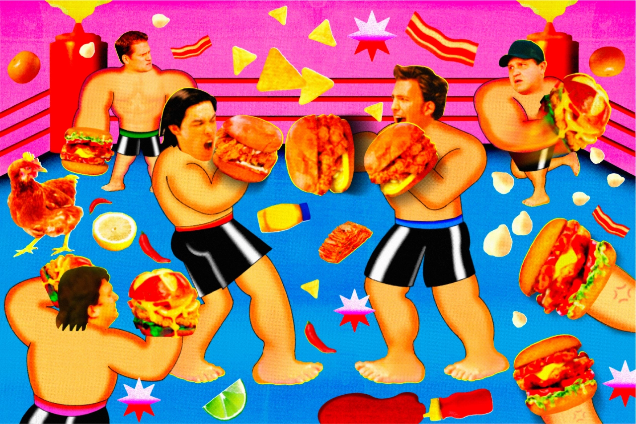 Shirtless men flexing and playfully fighting over oversized fried chicken sandwiches against a bright pink and blue background with geometric shapes