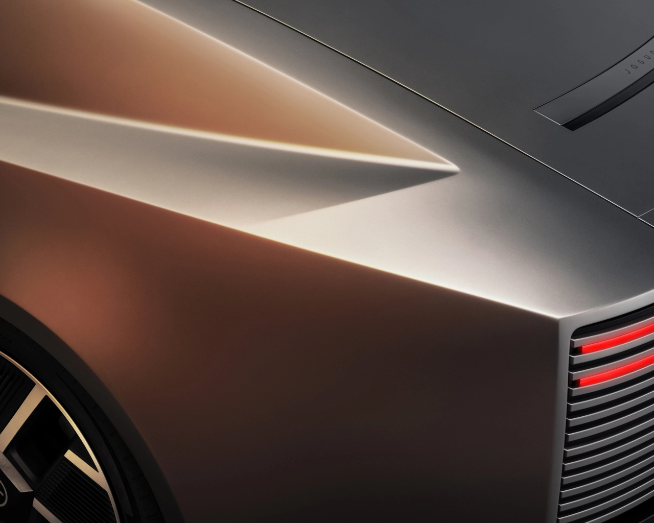 Close-up detail of the Jaguar Type 01's sleek metallic bodywork and illuminated panel line, with a glimpse of its tail light and wheel