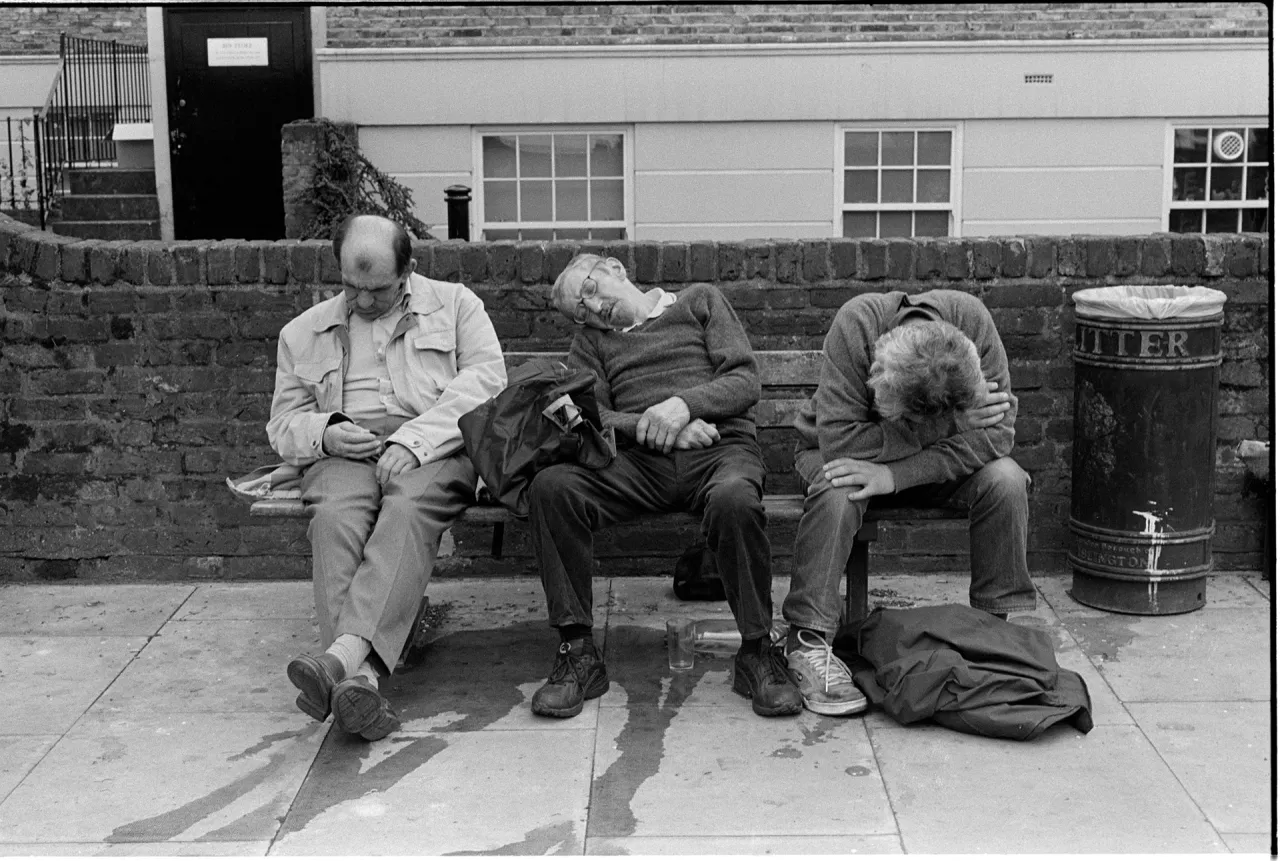 Men sit after the last ever football match at Highbury Stadium before Arsenal move to the new Emirates Stadium. Highbury Corner - 2006