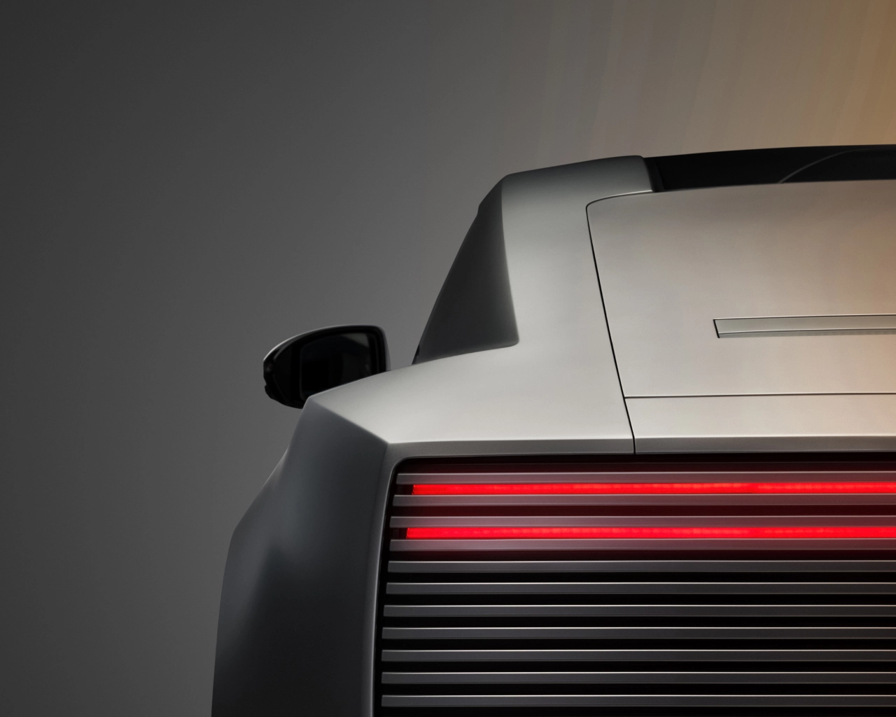 Detail of the new Jaguar Type 01's rear end, showing its distinctive red and black horizontal light bar against the silver body