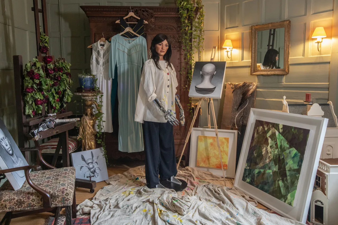 Ai-Da with her paintings. Photography by Victor Frankowski