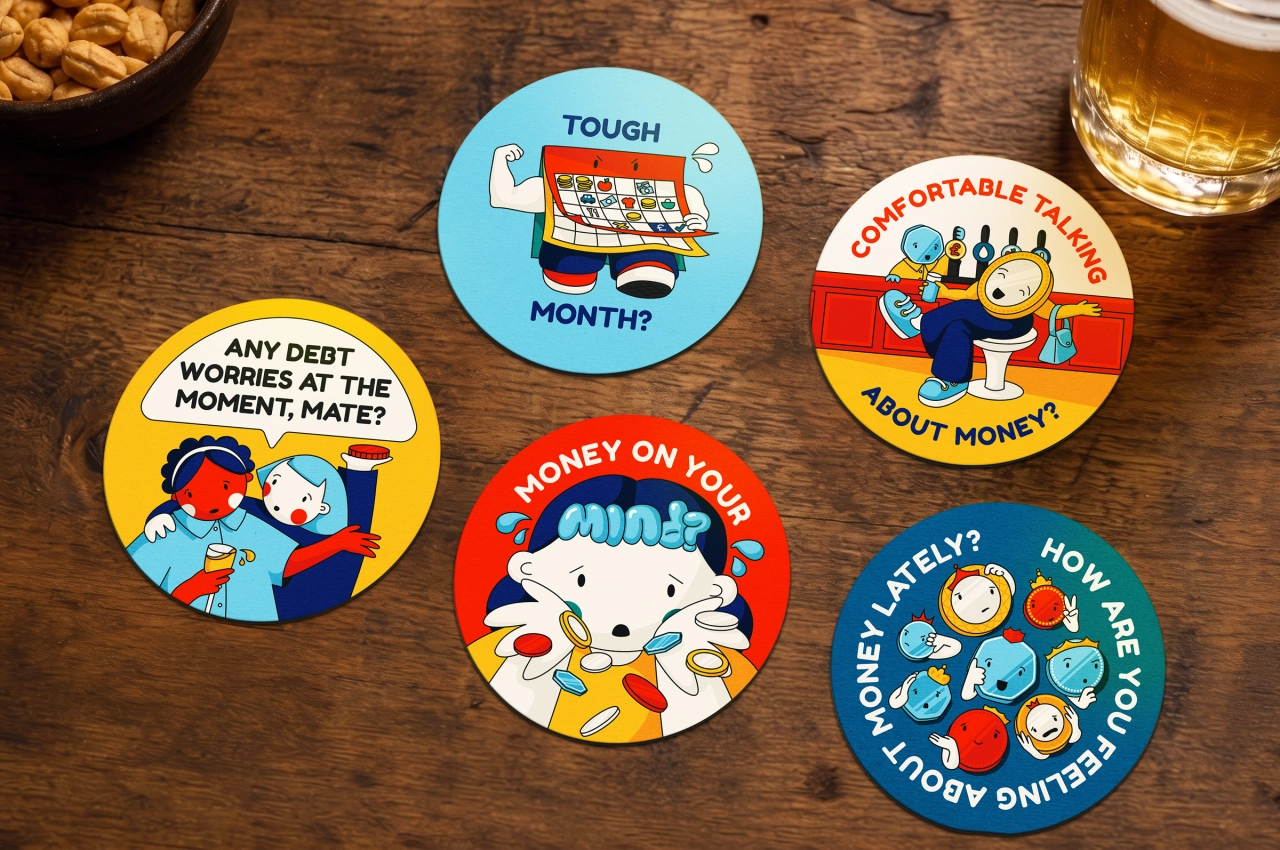 Five illustrated coasters featuring characters discussing financial topics including debt worries, tough months and money concerns, arranged on a wooden surface with snacks and beer