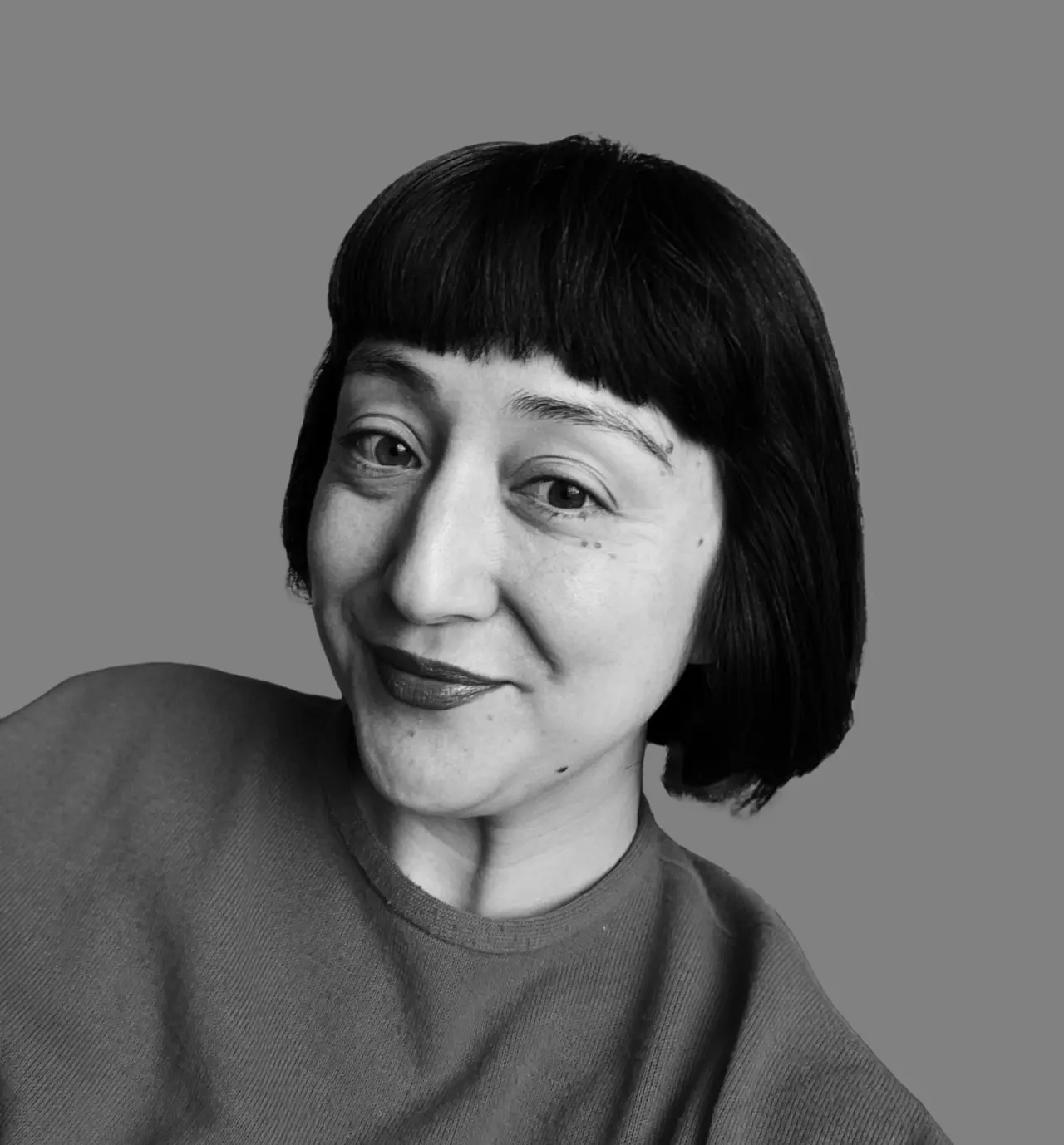 Black and white portrait of Elisa Maezono, creative director at Elmwood, against a grey background
