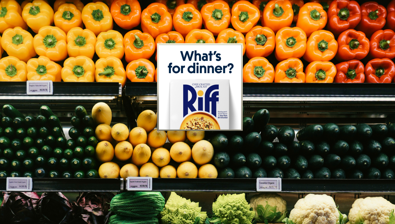 Colourful bell peppers and other fresh vegetables displayed on supermarket shelves with a Riff meal kit box and "What's for dinner?" advertising card in the centre