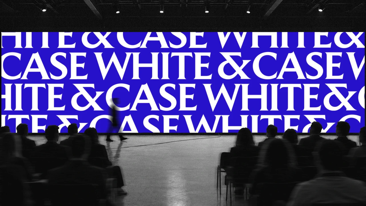 Silhouetted figures walk beneath a large blue screen displaying repeating "White & Case" text in white capital letters inside a dark venue