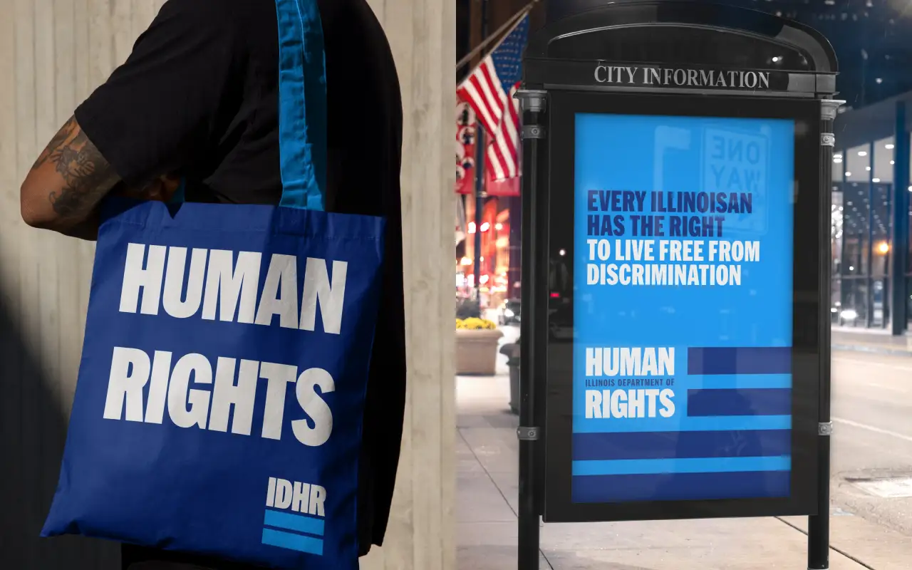 Blue IDHR tote bag printed with HUMAN RIGHTS text beside a public information display showing the message "Every Illinoisan has the right to live free from discrimination