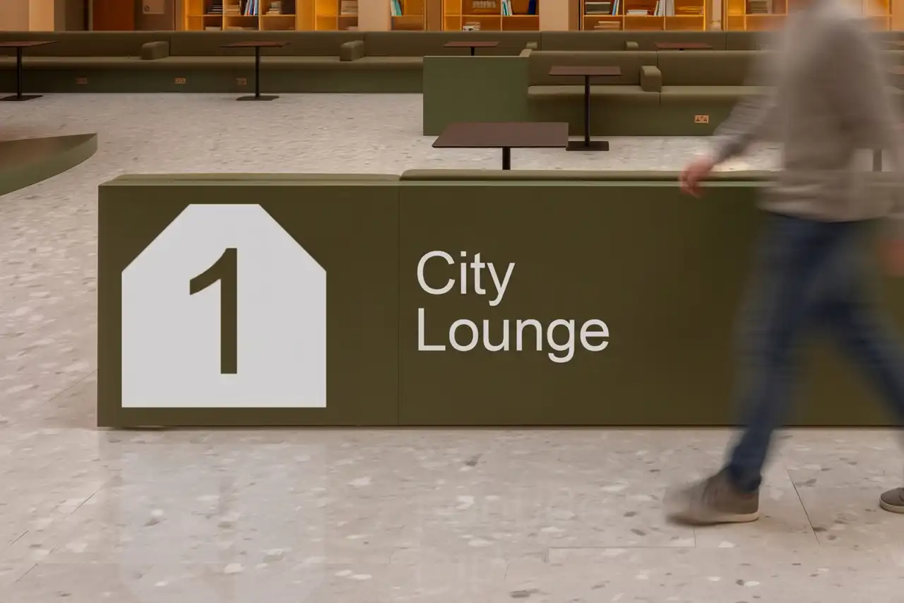 A brown signage for City Lounge with a house symbol and the number 1, inside Culture House Sunderland's interior space