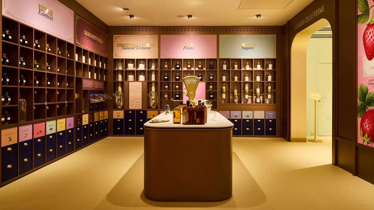 Interior of Leone's Happiness Factory retail space featuring wall-to-wall wooden display cabinets filled with colourful confectionery products and a central counter