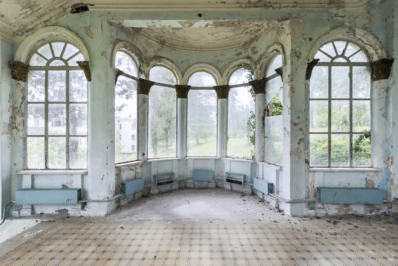 Broken glass and peeling paint - this beautiful passage is slowly deteriorating with the passing of time. The blue boxes on the wall were part of the heating system, so patients and guests could enjoy a view on the magnificent gardens during winter time as well. Tskaltubo, Georgia. © Reginald Van de Velde. All images courtesy of the photographer, via Creative Boom submission