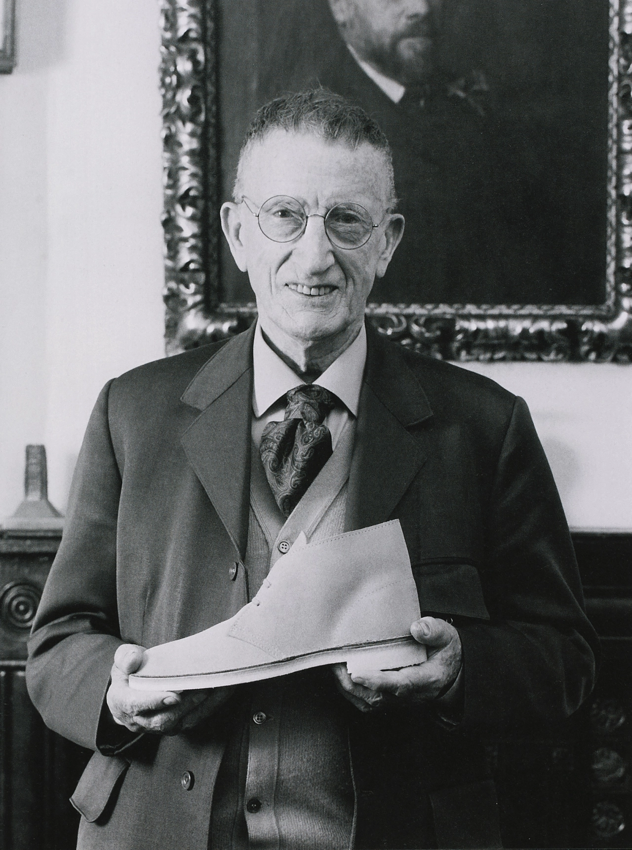 Nathan Clark, great-grandson of company founder James Clark, photographed in 1997 in Street, Somerset with his most well-known shoe design, the Desert Boot. Photographer unknown. Courtesy AGTA/CJC