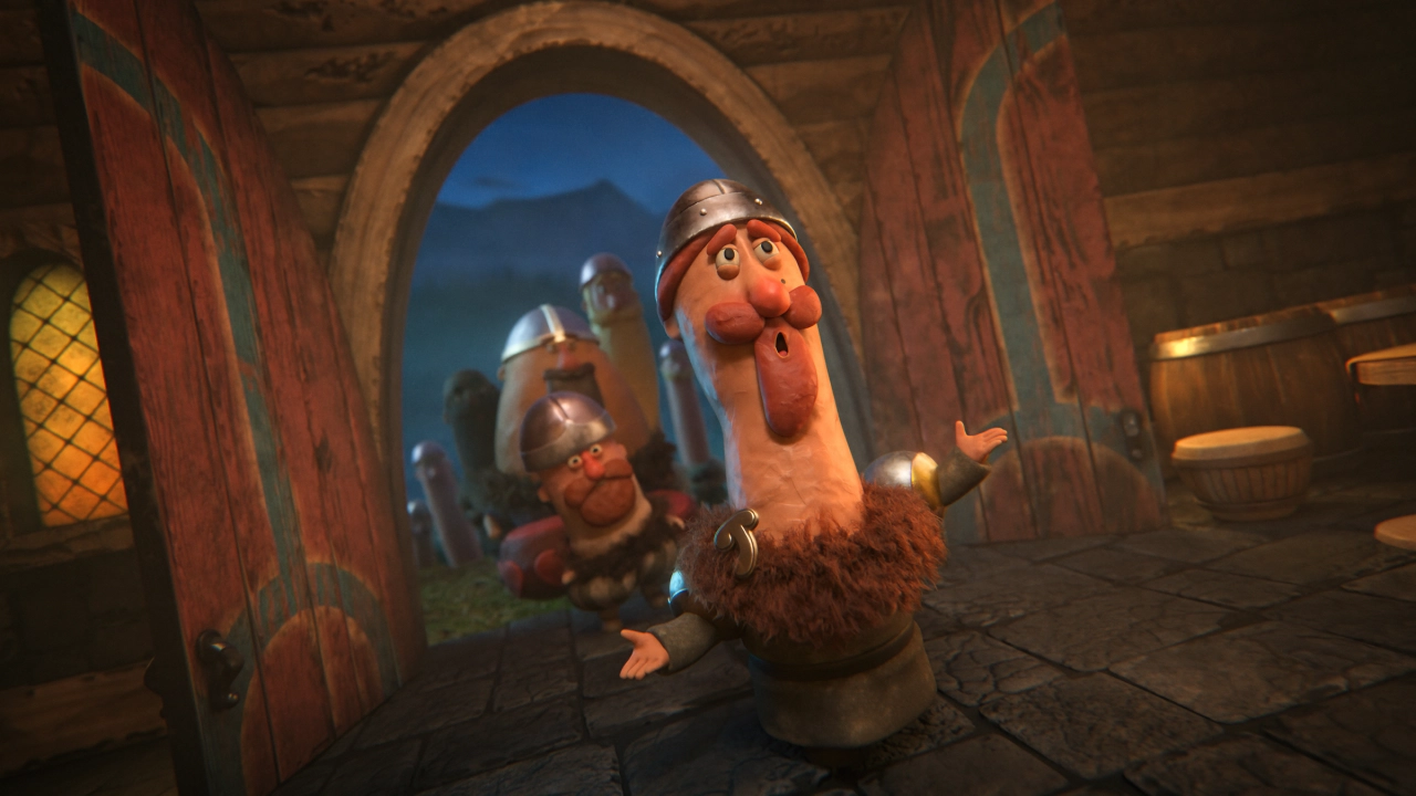 Jordic the animated Viking character stands with arms outstretched inside a wooden Viking hall, flanked by fellow Vikings in helmets and armour
