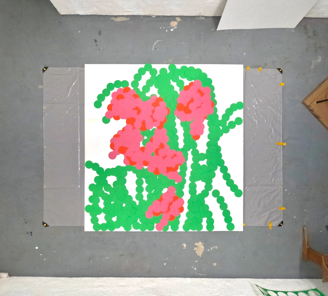 Vibrant abstract artwork of bright pink and coral blooms against fresh green foliage and stems, created with hand-cut paper