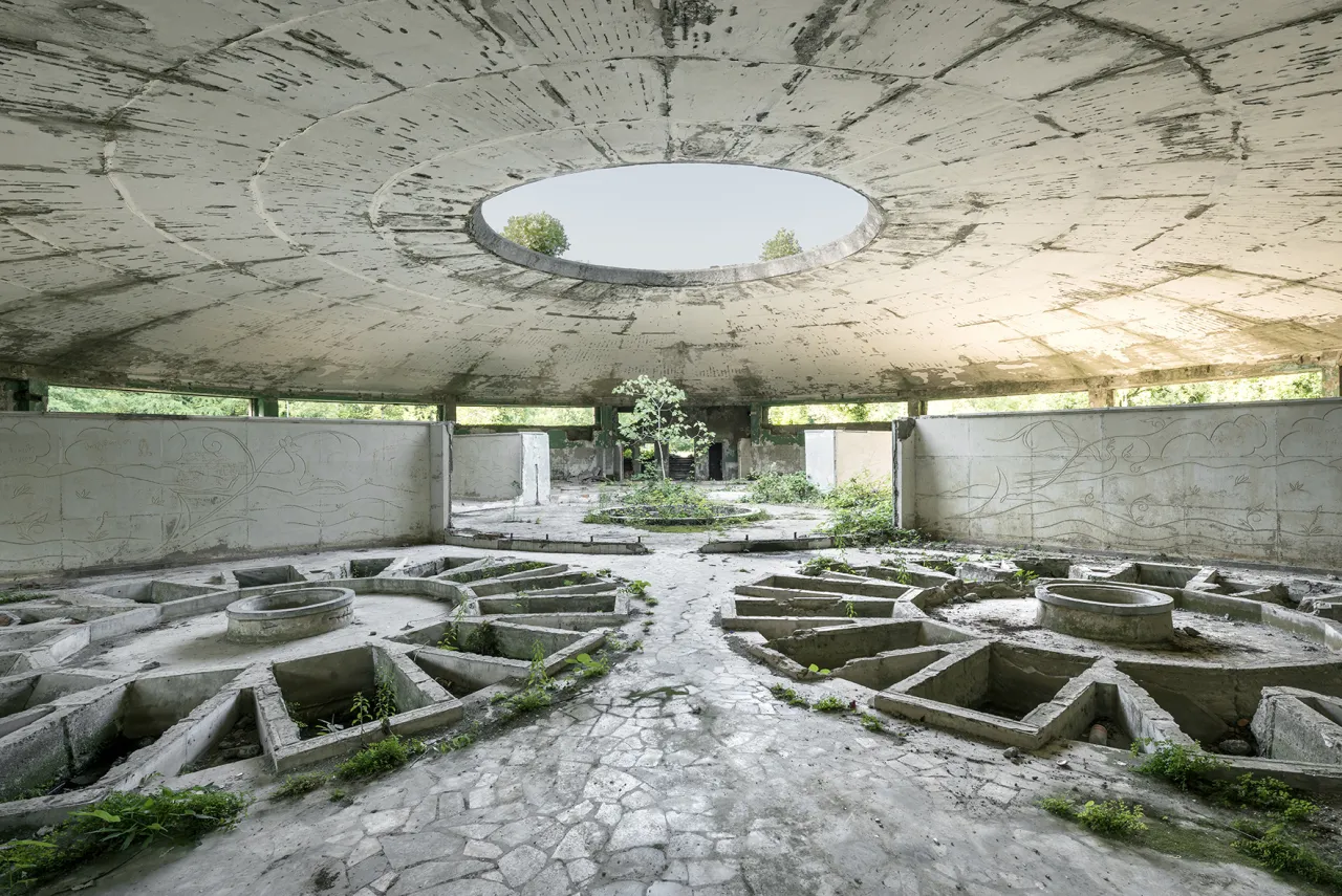 The remains of a thermal spa featuring a circular setup of individual tubs, a setup that would allow many people to bathe at once. Tskaltubo, Georgia. © Reginald Van de Velde