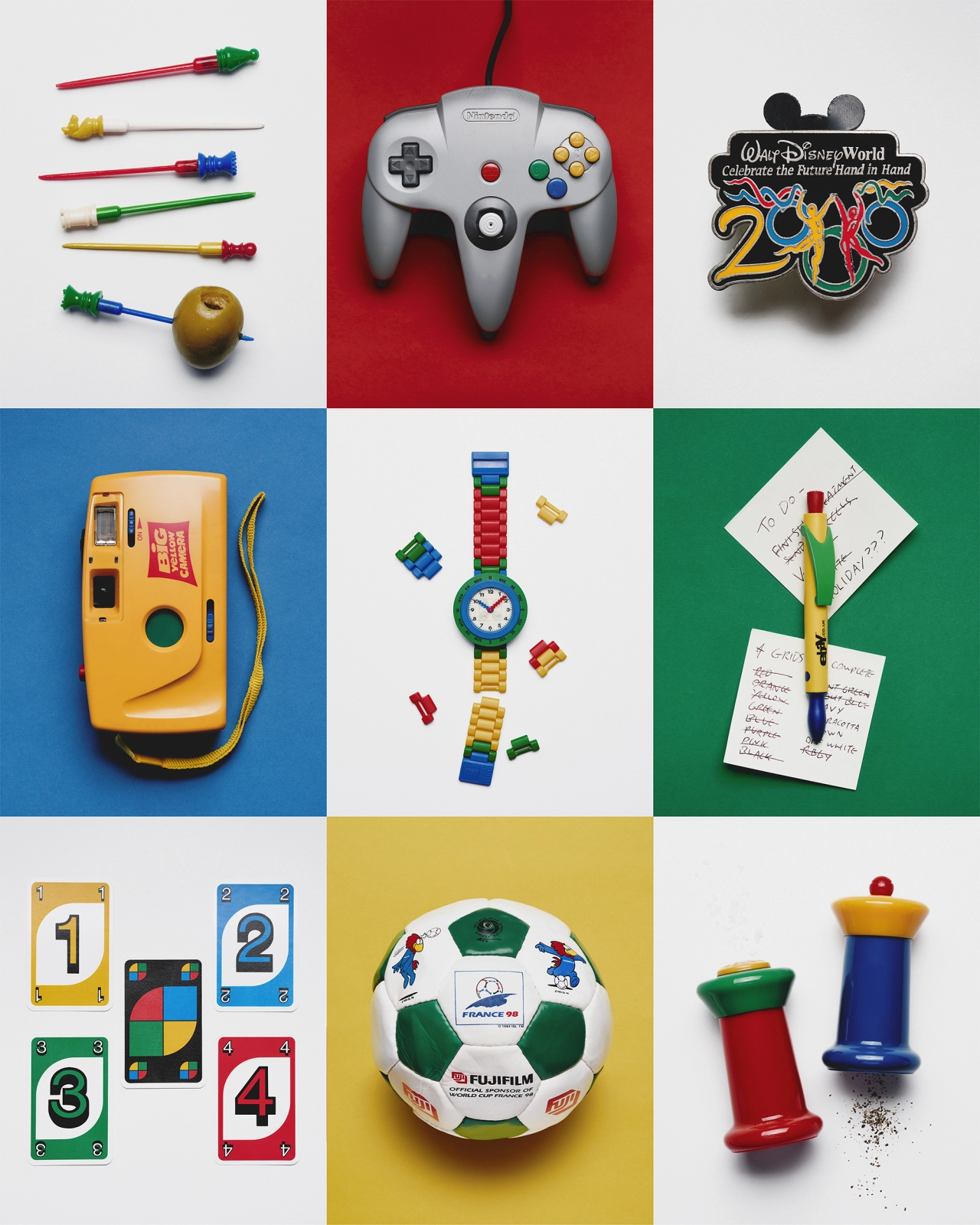 Grid of nine coloured backgrounds displaying vintage toys and objects including a Nintendo 64 controller, Disney World pin, yellow camera, Lego watch, parrot, numbered cards, football and pushpins