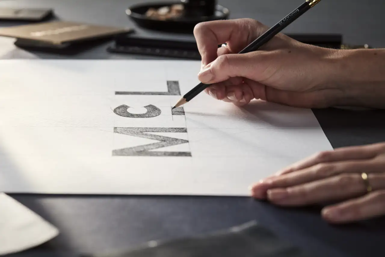 Hand painting the new McLaren wordmark with a brush, inspired by the original hand-painted service station sign