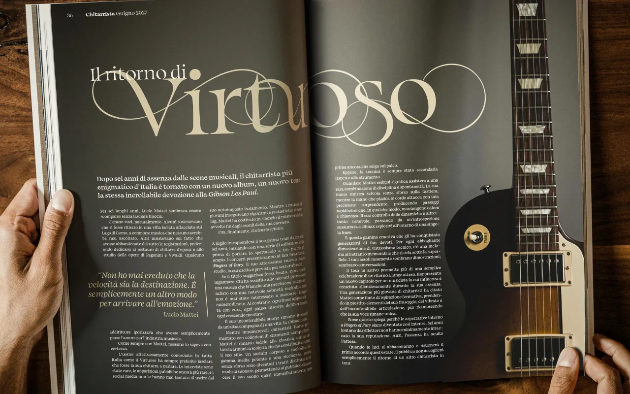 Hands holding open a magazine spread featuring the article "Il ritorno di Virtuoso" in large serif letterforms, with an electric guitar visible on the right side