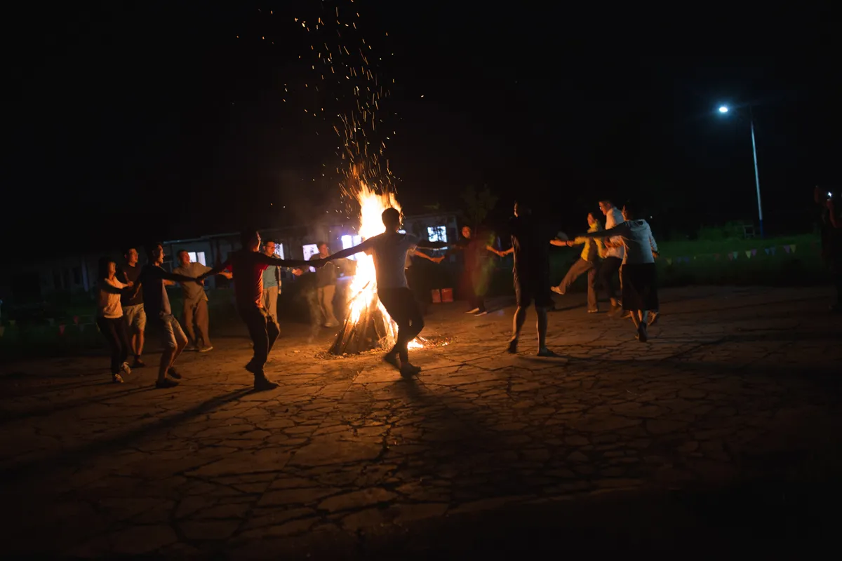 Heilongjiang Province, August 2017 Visiting university professors from Harbin take part in a fire ritual put on as a show by local Oroqen entrepreneurs. Interest in an ethnographically focused tourism industry and folk rituals are growing across contemporary China.
