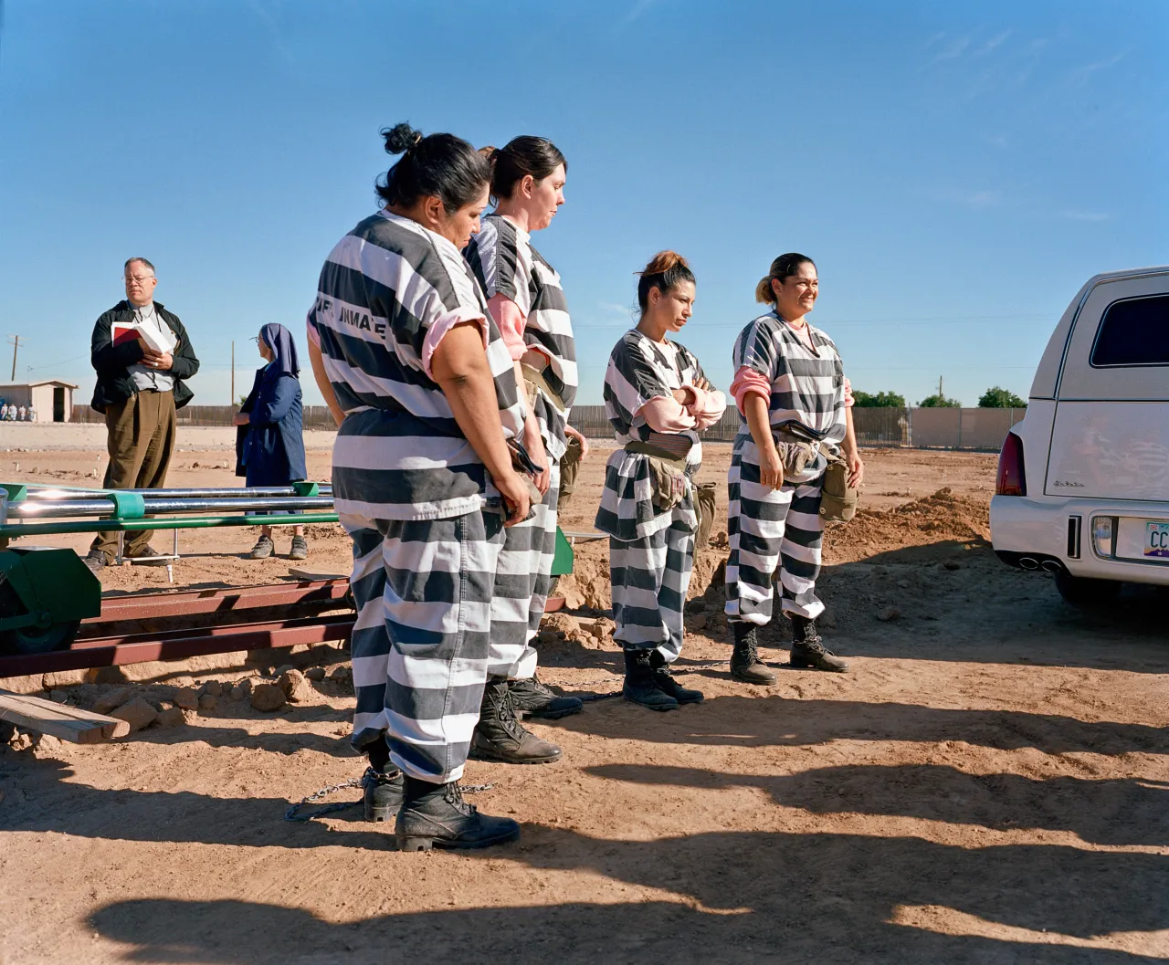 Inmates wait for a coffin during “ burial duty, ” at Whitetanks cemetery