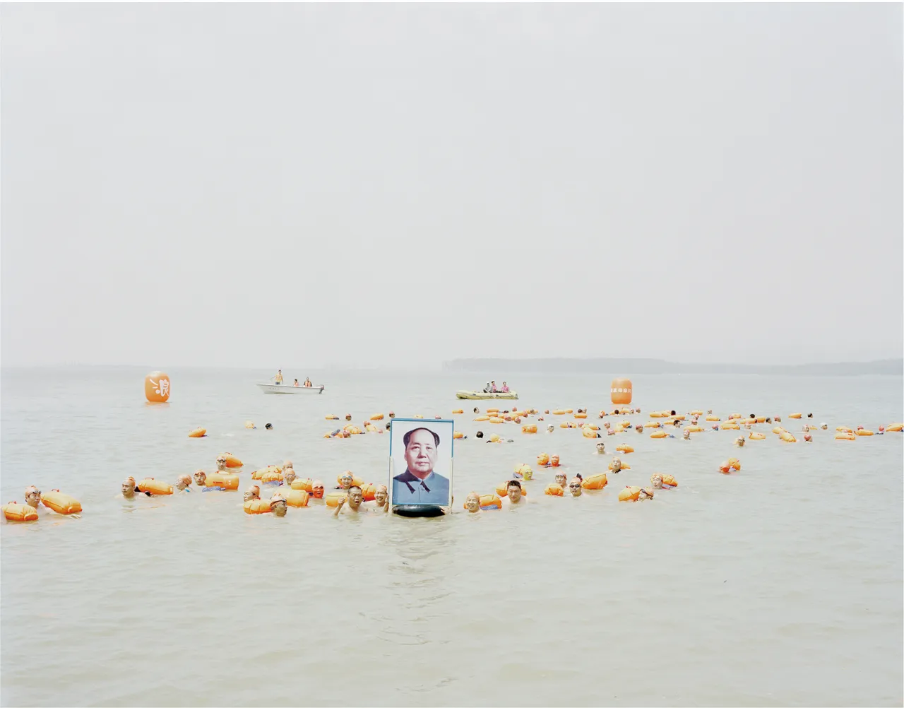 People crossing the river with a photo of Mao Zedong, Henan, 2012 © Zhang Kechun