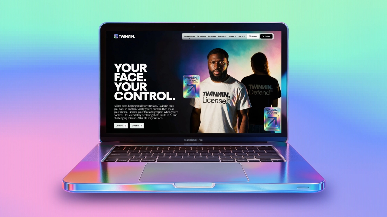 Laptop displaying Twinnin's website with tagline "Your Face Your Control" and two people wearing branded t-shirts, set against a gradient blue and pink background