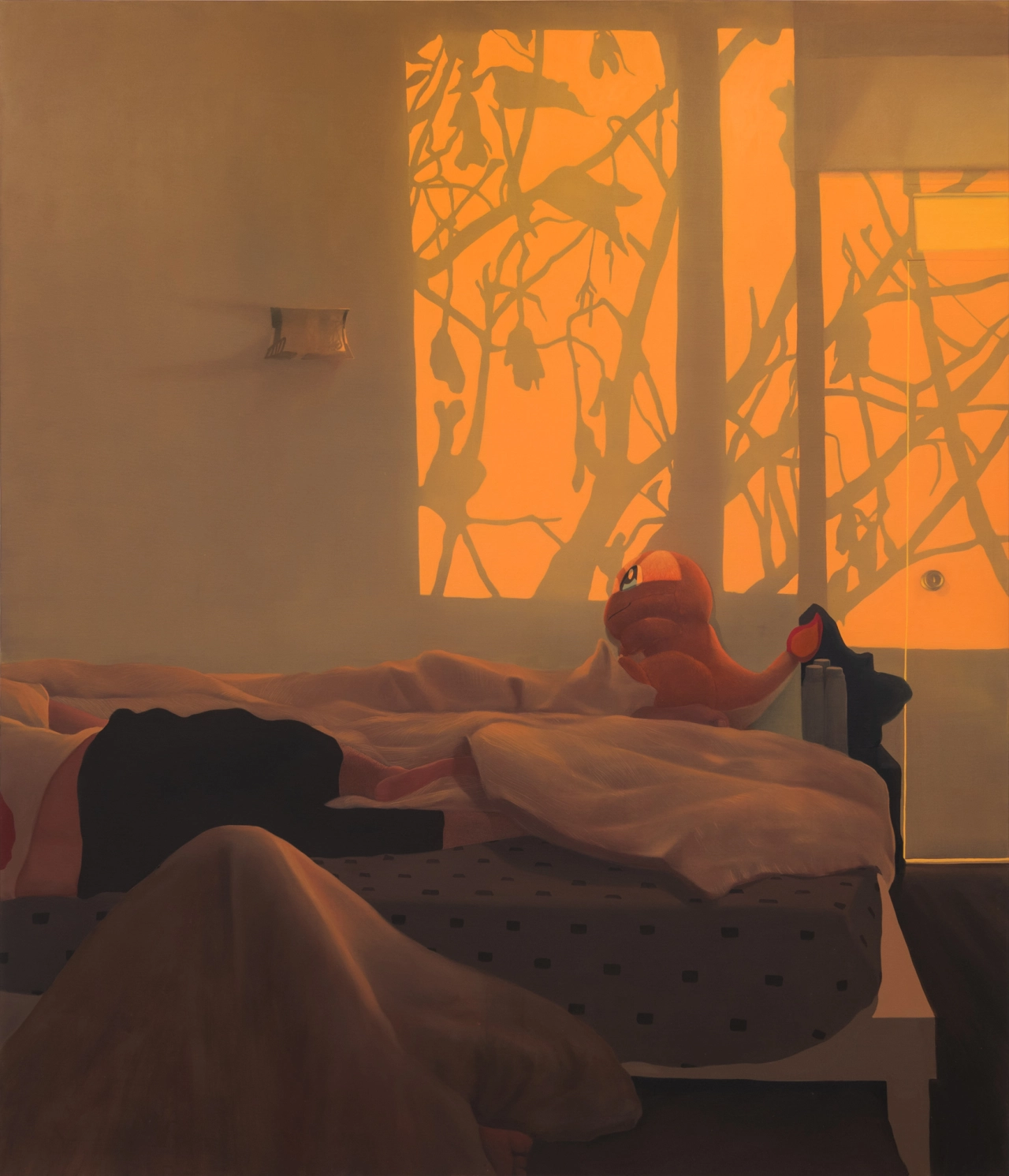 Warm orange light filters through windows casting leaf shadows across a rumpled bed in a minimalist interior space