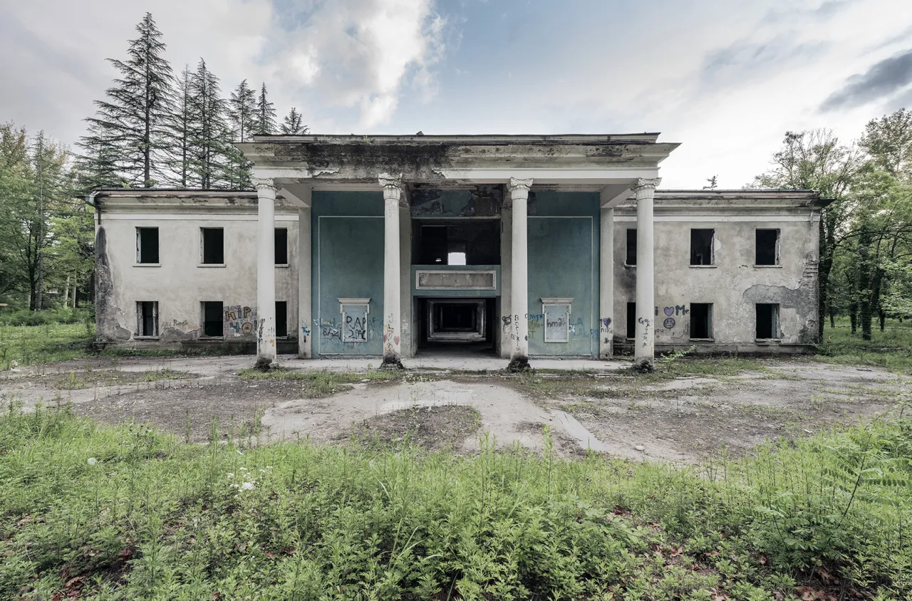 The exterior view on one of the many remaining spas. Men & women bathed separately, explaining a mirrored layout of the bathhouses. Tskaltubo, Georgia. © Reginald Van de Velde
